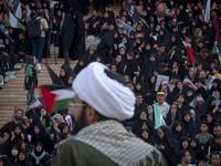 An Iranian cleric is looking at veiled women who are participating in a family rally to support mandatory hijab, at the Azadi (Freedom) Stad...