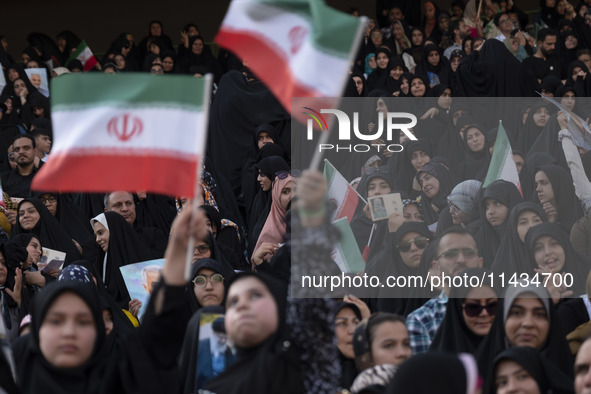 Veiled Iranian women and their families are participating in a family rally to support mandatory hijab at the Azadi (Freedom) Stadium in wes...