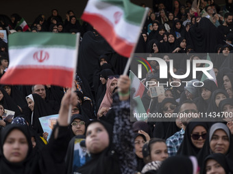 Veiled Iranian women and their families are participating in a family rally to support mandatory hijab at the Azadi (Freedom) Stadium in wes...