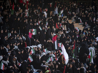 A young Iranian woman is adjusting her headscarf while participating in a family rally to support mandatory hijab, at the Azadi (Freedom) St...