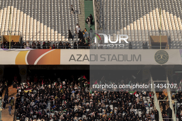 Veiled Iranian women and their families are participating in a family rally to support mandatory hijab at the Azadi (Freedom) Stadium in wes...