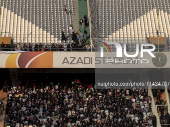 Veiled Iranian women and their families are participating in a family rally to support mandatory hijab at the Azadi (Freedom) Stadium in wes...