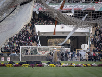 A religious flag and headbands are hanging and tied on soccer goals, while a cleric is delivering speeches, during a family rally to support...