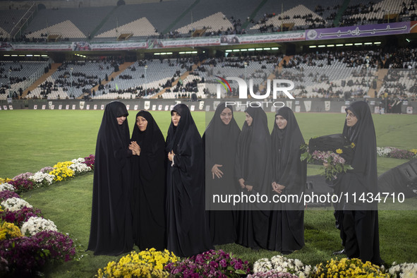 A group of veiled clergywomen are performing in a family rally to support mandatory hijab at the Azadi (Freedom) Stadium in western Tehran,...