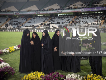 A group of veiled clergywomen are performing in a family rally to support mandatory hijab at the Azadi (Freedom) Stadium in western Tehran,...