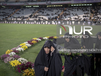 A group of veiled clergywomen are walking together after performing in a family rally to support mandatory hijab, at the Azadi (Freedom) Sta...