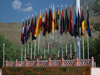 Indian army personnel are standing under regimental flags at a war memorial during the ''Vijay Diwas'' or Victory Day celebration in Drass,...