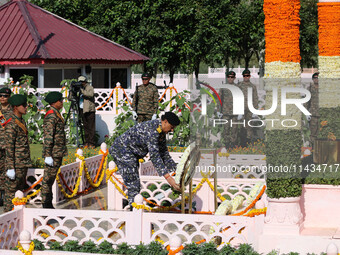 Indian Navy Chief Admiral Dinesh K Tripathi PVSM is laying a wreath at a war memorial during ''Vijay Diwas'' or Victory Day celebration in D...