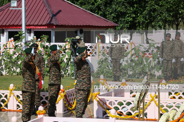 Indian Army Chief Upendra Dwivedi is saluting to pay tribute at a war memorial during the ''Vijay Diwas'' or Victory Day celebration in Dras...