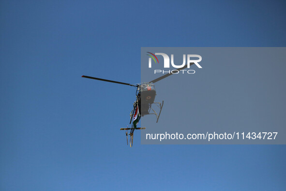 An Indian army helicopter is flying over the sky during the ''Vijay Diwas'' or Victory Day celebration in Drass, about 160 km (99 miles) eas...