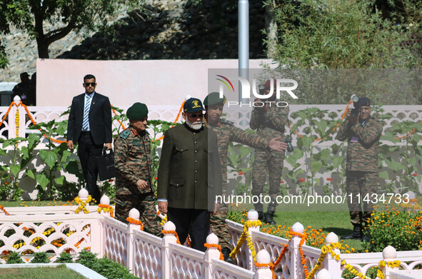 Indian Prime Minister Narendra Modi (C) and senior Army officers are being seen at a war memorial during the ''Vijay Diwas'' or Victory Day...