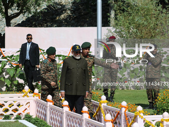 Indian Prime Minister Narendra Modi (C) and senior Army officers are being seen at a war memorial during the ''Vijay Diwas'' or Victory Day...