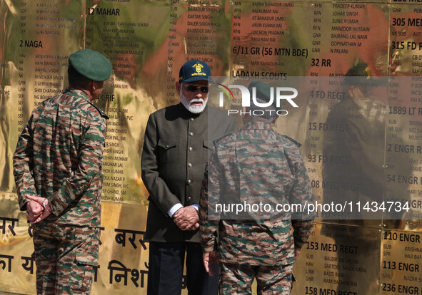 Indian Prime Minister Narendra Modi (C) and senior Army officers are being seen at a war memorial during the ''Vijay Diwas'' or Victory Day...