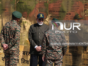 Indian Prime Minister Narendra Modi (C) and senior Army officers are being seen at a war memorial during the ''Vijay Diwas'' or Victory Day...