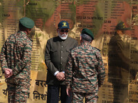 Indian Prime Minister Narendra Modi (C) and senior Army officers are being seen at a war memorial during the ''Vijay Diwas'' or Victory Day...