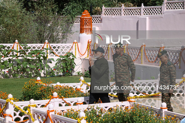 Indian Prime Minister Narendra Modi (C) and senior Army officers are being seen at a war memorial during the ''Vijay Diwas'' or Victory Day...