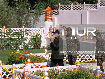 Indian Prime Minister Narendra Modi (C) and senior Army officers are being seen at a war memorial during the ''Vijay Diwas'' or Victory Day...