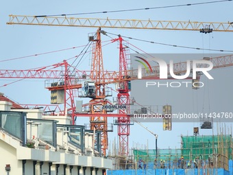 Tower cranes are being seen at a real estate construction site in Yantai, Shandong province, China, on July 23, 2024. On July 15, 2024, the...