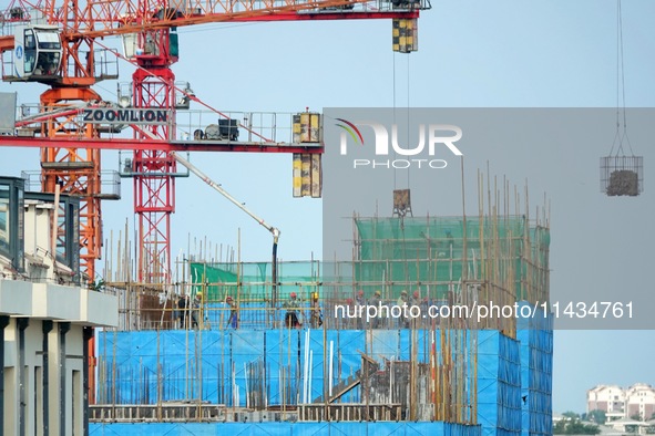 Tower cranes are being seen at a real estate construction site in Yantai, Shandong province, China, on July 23, 2024. On July 15, 2024, the...