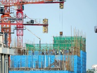 Tower cranes are being seen at a real estate construction site in Yantai, Shandong province, China, on July 23, 2024. On July 15, 2024, the...