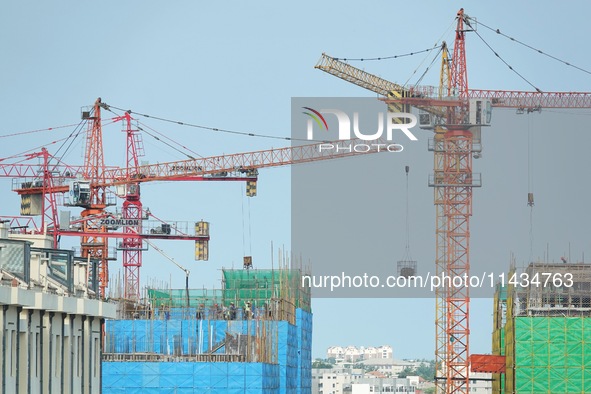 Tower cranes are being seen at a real estate construction site in Yantai, Shandong province, China, on July 23, 2024. On July 15, 2024, the...