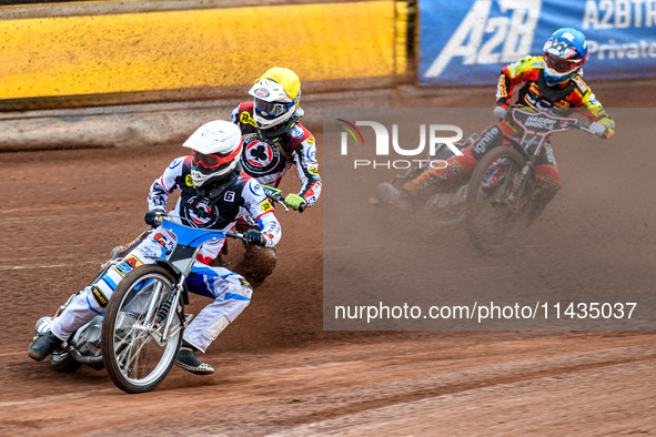 Belle Vue Aces' Antti Vuolas in white and teammate Jake Mulford in yellow are leading Leicester Lions' Sam Hagon in blue during the Rowe Mot...