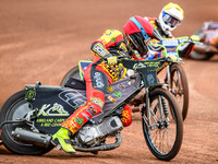 Leicester Lions' Craig Cook in red is leading Belle Vue Aces' Jake Mulford in yellow during the Rowe Motor Oil Premiership match between Lei...