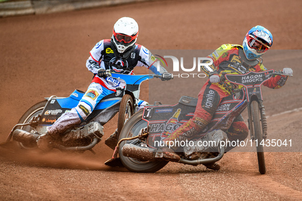 Leicester Lions' Sam Hagon in blue is leading Belle Vue Aces' Antti Vuolas in white during the Rowe Motor Oil Premiership match between Leic...