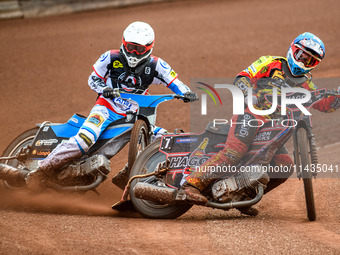 Leicester Lions' Sam Hagon in blue is leading Belle Vue Aces' Antti Vuolas in white during the Rowe Motor Oil Premiership match between Leic...