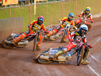 Belle Vue Aces' Brady Kurtz in White is leading Leicester Lions' Sam Masters in Red, Leicester Lions' Luke Becker in Blue, and Belle Vue Ace...