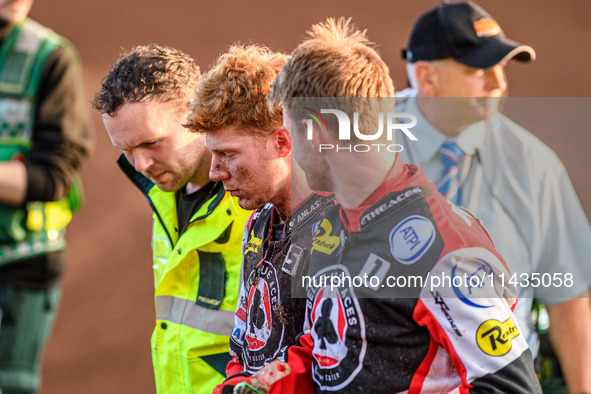 Belle Vue Aces' Dan Bewley (center) is being helped back to the pits after his crash by Belle Vue Aces' Brady Kurtz (right) and the paramedi...