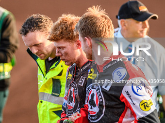 Belle Vue Aces' Dan Bewley (center) is being helped back to the pits after his crash by Belle Vue Aces' Brady Kurtz (right) and the paramedi...