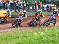 Belle Vue Aces' Jaimon Lidsey in White is leading Leicester Lions' Max Fricke in Red, Leicester Lions' Richard Lawson in Blue, and Belle Vue...