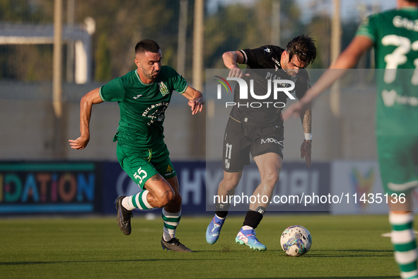 Joao Silva (R) of Vitoria SC is moving away with the ball from the close challenge of Alexandros Kouro (L) of Floriana during the UEFA Europ...