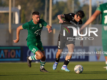 Joao Silva (R) of Vitoria SC is moving away with the ball from the close challenge of Alexandros Kouro (L) of Floriana during the UEFA Europ...