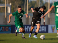 Joao Silva (R) of Vitoria SC is moving away with the ball from the close challenge of Alexandros Kouro (L) of Floriana during the UEFA Europ...