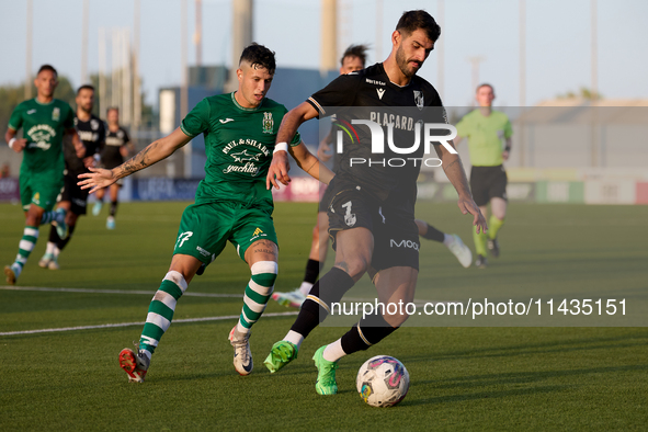 Nelson Oliveira (R) of Vitoria SC is being closely followed by Alejandro Garzia (L) of Floriana during the UEFA Europa Conference League, Se...