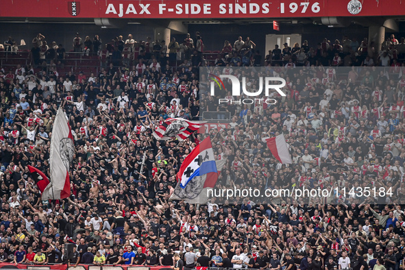 Supporters of Ajax are cheering during the match Ajax vs. Vojvodina at the Johan Cruijff ArenA for the UEFA Europa League Second qualifying...