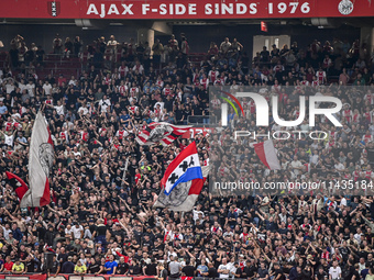 Supporters of Ajax are cheering during the match Ajax vs. Vojvodina at the Johan Cruijff ArenA for the UEFA Europa League Second qualifying...