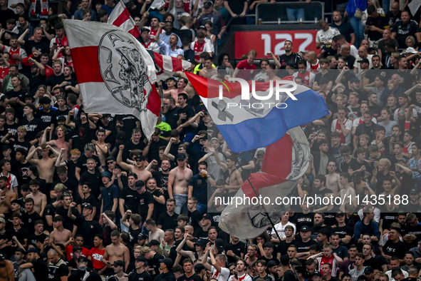 Supporters of Ajax are cheering during the match Ajax vs. Vojvodina at the Johan Cruijff ArenA for the UEFA Europa League Second qualifying...