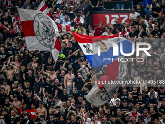 Supporters of Ajax are cheering during the match Ajax vs. Vojvodina at the Johan Cruijff ArenA for the UEFA Europa League Second qualifying...