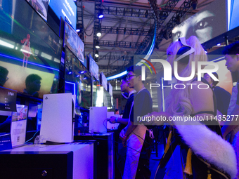 A cosplayer is playing games at the PlayStation game booth during the Chinajoy games fair in Shanghai, China, on July 26, 2024. (