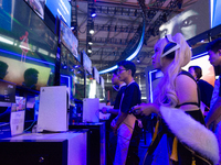 A cosplayer is playing games at the PlayStation game booth during the Chinajoy games fair in Shanghai, China, on July 26, 2024. (