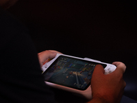 A fairgoer is playing games during the Chinajoy games fair in Shanghai, China, on July 26, 2024. (