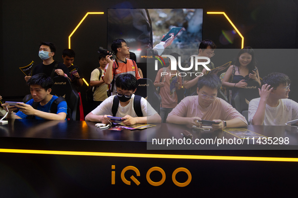 A general view of fairgoers is being seen at the IQOO communication technology booth during the Chinajoy games fair in Shanghai, China, on J...