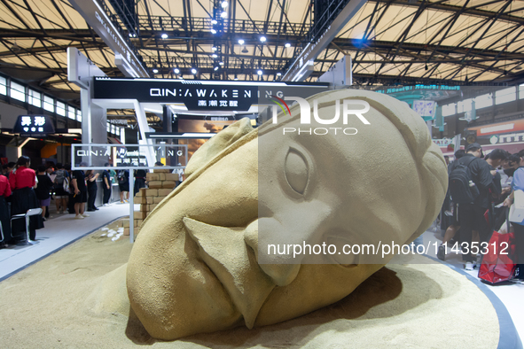 A large sand sculpture is being seen in front of the Awakening Games booth during the Chinajoy Games Fair in Shanghai, China, on July 26, 20...