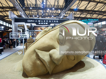 A large sand sculpture is being seen in front of the Awakening Games booth during the Chinajoy Games Fair in Shanghai, China, on July 26, 20...