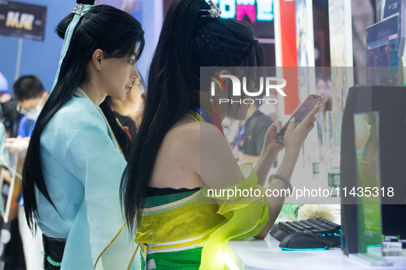 Cosplayers are playing games at the Chinajoy games fair in Shanghai, China, on July 26, 2024. 