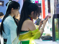 Cosplayers are playing games at the Chinajoy games fair in Shanghai, China, on July 26, 2024. (