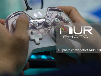 A player is playing with a game controller at Chinajoy games fair in Shanghai, China, on July 26, 2024. (